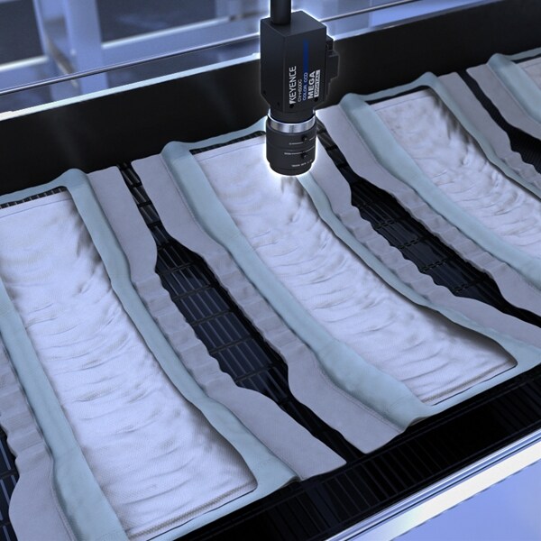 Stain inspection on non-woven fabrics